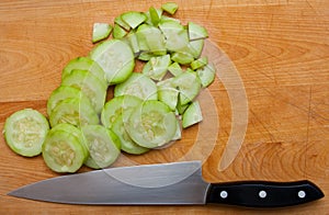 Cucumber Slices With Knife On Cutting Board