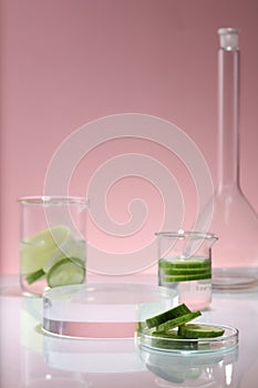 Cucumber slices is put inside beakers and a petri dish, decorated with round transparent pedestal