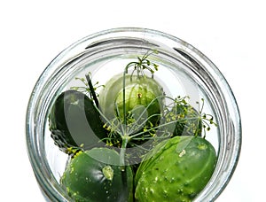 Cucumbers in jar with herbs