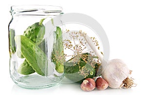 Cucumbers in jar preparate for preserving on white