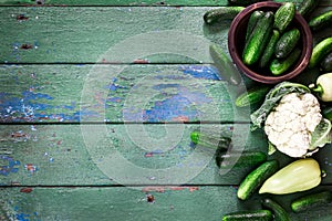 Cucumbers on old green wooden table.