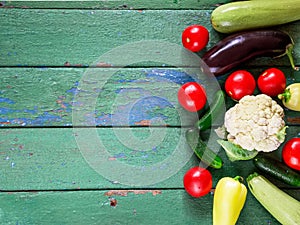 Cucumbers on old green wooden table.