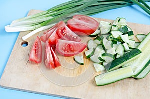 cucumbers and tomatoes on a cutting board