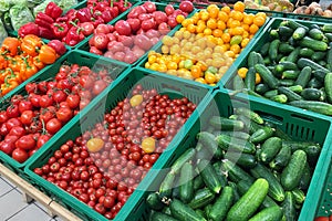Cucumbers, tomatoes and peppers are sold at the grocery store. Vegetables on the market.