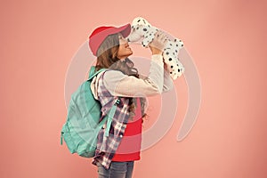 Cuddly little plaything. Happy small child play with toy present on pink background. Little girl smile with toy dog