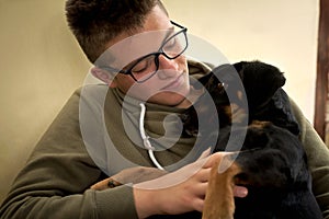 Cuddly young dog in the arms of a man photo