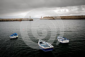 CUDILLE, SPAIN - Jul 16, 2014: Bonita estampa de tres barcas en el puerto photo