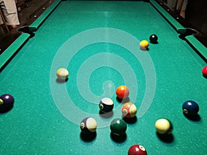 Cue aim billiard snooker pyramid on green table. A Set of snookers/pool balls on Billiards table.