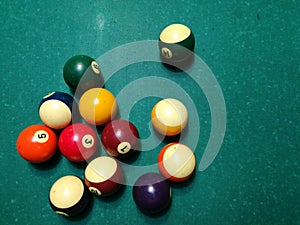 Cue aim billiard snooker pyramid on green table. A Set of snookers/pool balls on Billiards table.