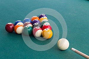 Cue aiming white ball to break snooker billards on table