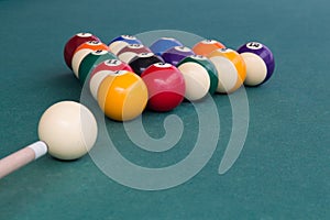 Cue aiming white ball to break snooker billards on table