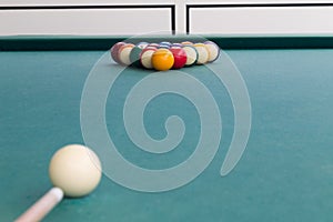 Cue aiming white ball to break snooker billards on table