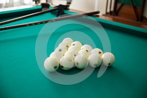 Cue ball for Russian billiards on the table. White billiard balls on the background.