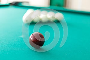 Cue ball for Russian billiards on the table. White billiard balls on the background.