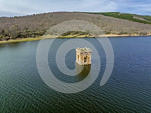 Cuerda del Pozo reservoir the bell tower of the church of La Muedra Soria province photo