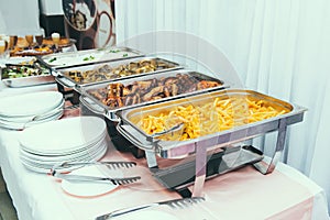 Cuisine Culinary Buffet Dinner Dining Food Celebration Party Concept. Trays with main meals - french fries chips, rice