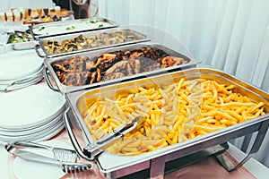 Cuisine Culinary Buffet Dinner Dining Food Celebration Party Concept. Trays with main meals - french fries chips, rice