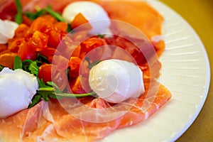 Cuisine of Emilia-Romagna region, Caprese salad with Prosciutto crudo, prosciutto di Parma, mozzarella cheese and tomatoes, lunch photo