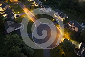 Cul de sac street dead end at night and private residential houses in rural suburban sprawl area in Rochester, New York