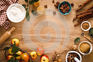 Culinary background. Cooking Thanksgiving autumn apple pie with fresh fruits and walnuts on wooden table