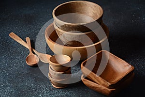 Culinary background : empty ceramic plates, wooden or bamboo spoons and bowls