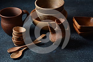 Culinary background : empty ceramic plates, wooden or bamboo spoons and bowls