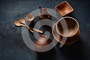 Culinary background : empty ceramic plates, wooden or bamboo spoons and bowls