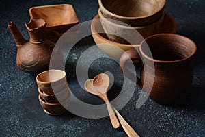 Culinary background : empty ceramic plates, wooden or bamboo spoons and bowls