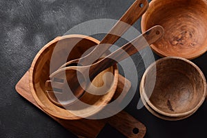 Culinary background, empty ceramic plates, wooden or bamboo spoons and bowls