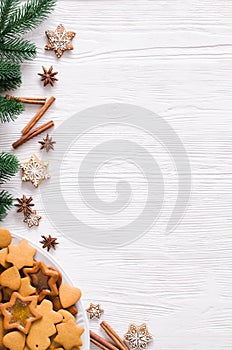 Culinary background with freshly baked Christmas gingerbread, spices and fir branches. Copy space