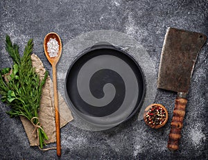 Culinary background with spices, pan and cleaver