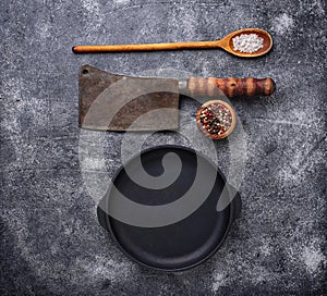 Culinary background with spices, pan and cleaver