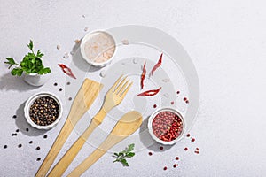 Culinary background with wooden kitchen utensil, spices and herbs. Set for preparation healthy food