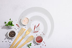 Culinary background with wooden kitchen utensil, spices and herbs. Set for preparation healthy food