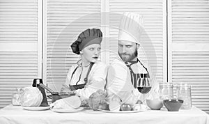 Culinary battle concept. Woman and bearded man culinary show competitors. Who cook better. Ultimate cooking challenge