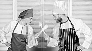 Culinary battle of two chefs. Couple compete in culinary arts. Kitchen rules. Culinary battle concept. Woman and bearded
