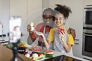 Culinary Blog. Happy Black Man And His Daughter Recording Video In Kitchen