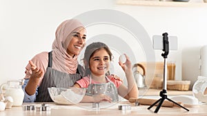 Culinary Blog. Happy Muslim Woman And Little Daughter Recording Video In Kitchen