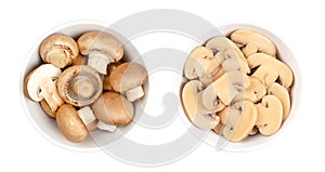 Cultivated brown mushrooms, fresh and canned champignions, in white bowl