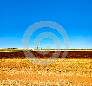 Cultivated ploughed field in farm agriculture area