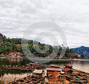 Cultivating fish in floating net cages on Lake Lut Tawar, Takengon, Aceh, Indonesia