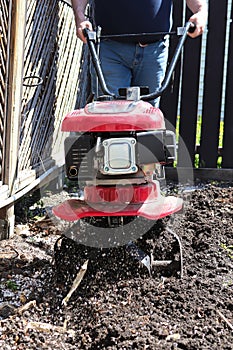 Cultivating garden soil in the spring with a rototiller