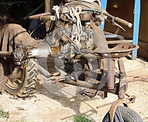 Cultivator old and rusty abandoned in a garage of the farm stora