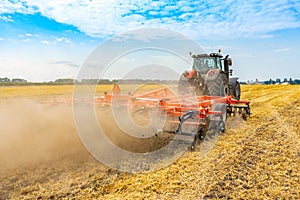 Cultivator with tractor working on the field