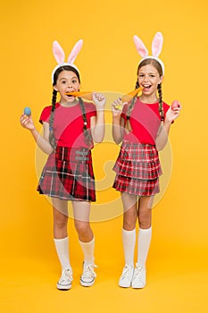 Culture and customs concept. Celebrate Easter with school friends. Easter preparations. Little schoolgirls long bunny