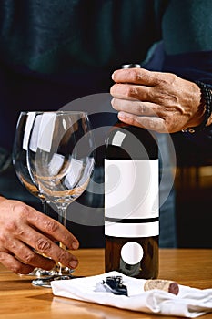 The culture of winemaking. Samelie offers wine, the hands of a winemaker with a glass of wine and an uncorked bottle