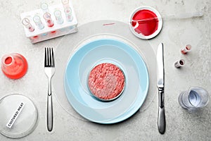 Cultured meat served on light grey lab table, flat lay