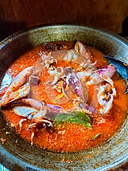 Cumi Balado or red chili squid. one of the typical Minangkabau dishes in Indonesia, fresh squid cooked with spicy chili sauce.