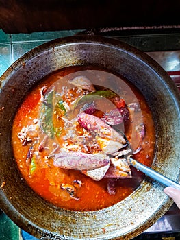 Cumi Balado or red chili squid. one of the typical Minangkabau dishes in Indonesia, fresh squid cooked with spicy chili sauce.