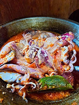 Cumi Balado or red chili squid. one of the typical Minangkabau dishes in Indonesia, fresh squid cooked with spicy chili sauce.